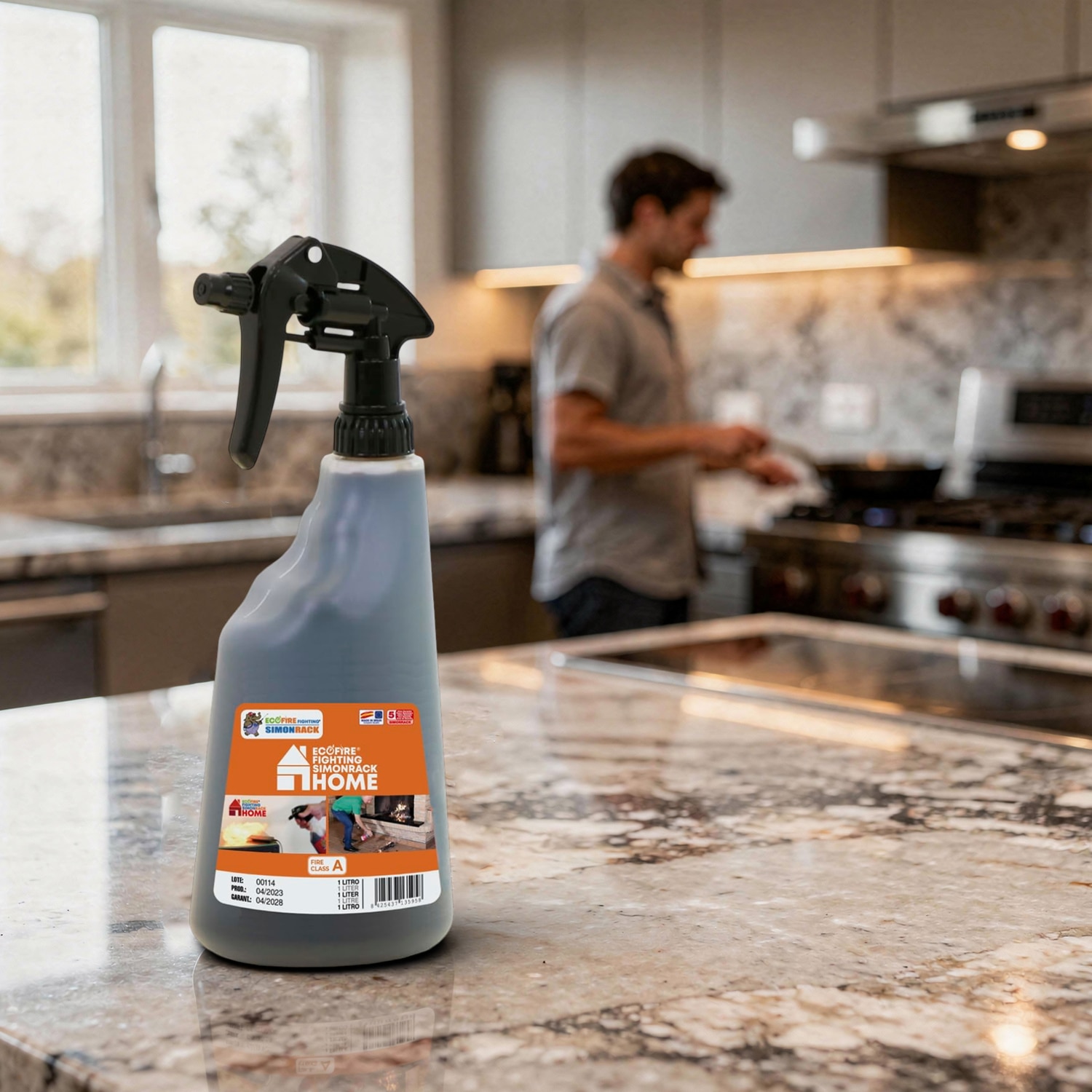 Spray protection incendie, pulvérisateur Ecofire 1 L posé sur un plan de travail de cuisine, en arrière plan un homme qui cuisine